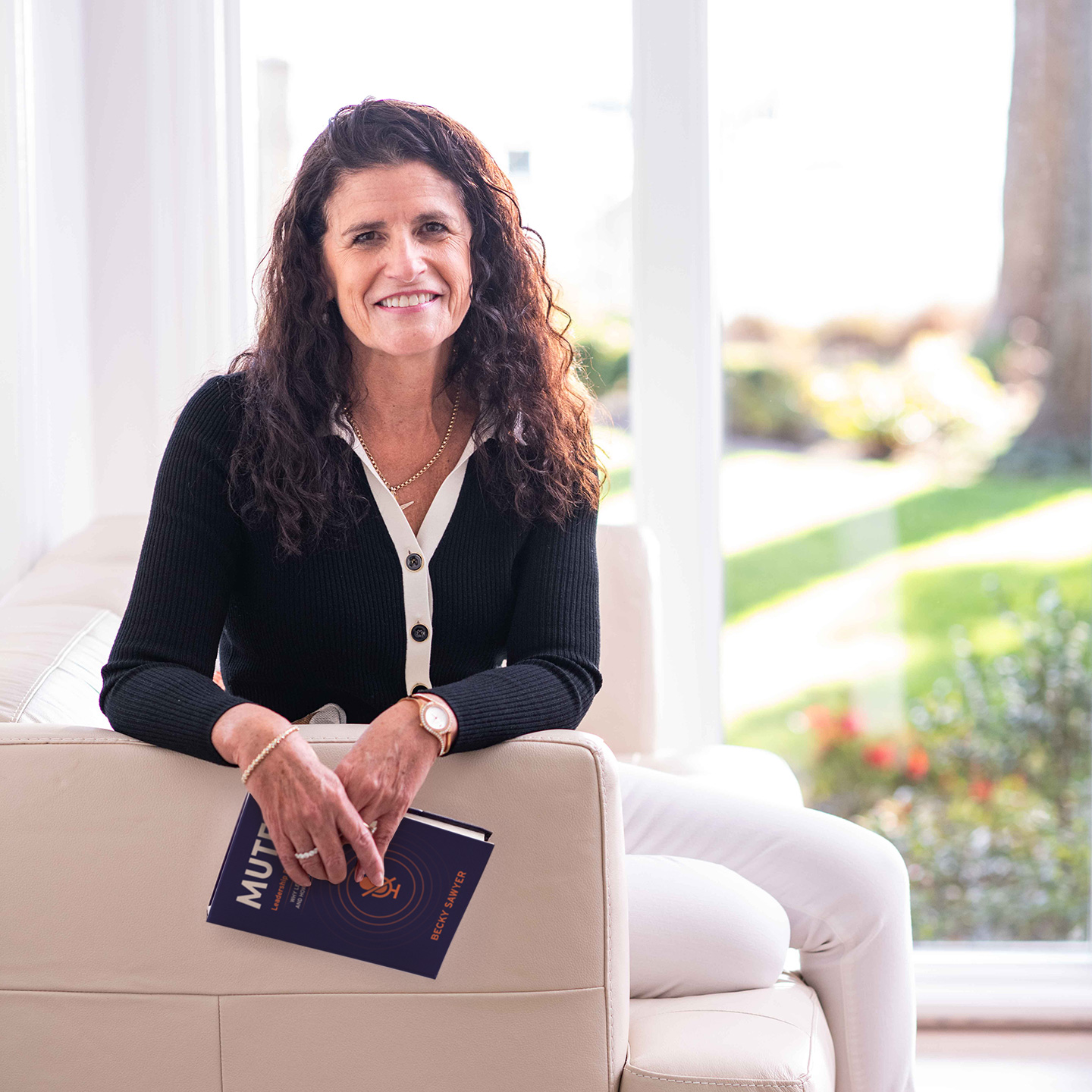 Headshot of Becky Sawyer holding her book, 